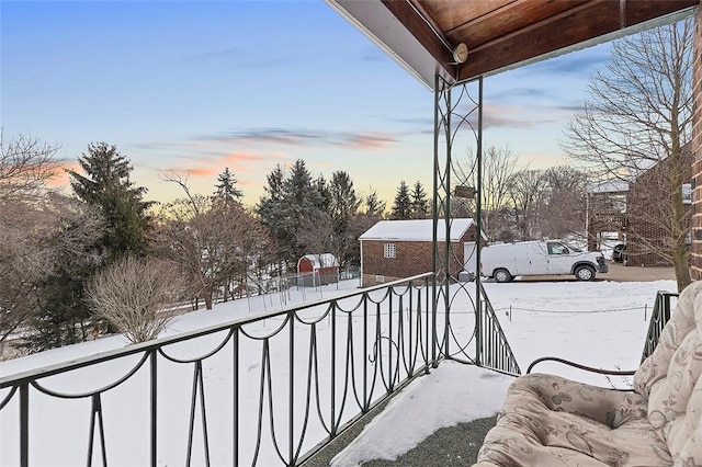 view of snow covered back of property