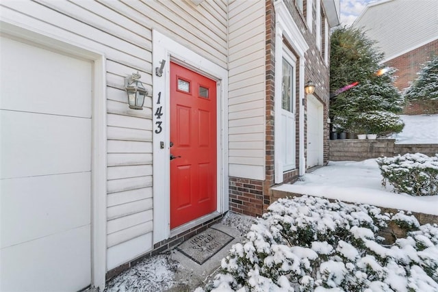 view of snow covered property entrance