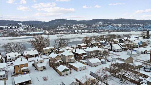 snowy aerial view featuring a mountain view