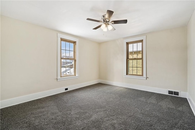 unfurnished room featuring ceiling fan, a wealth of natural light, and carpet flooring