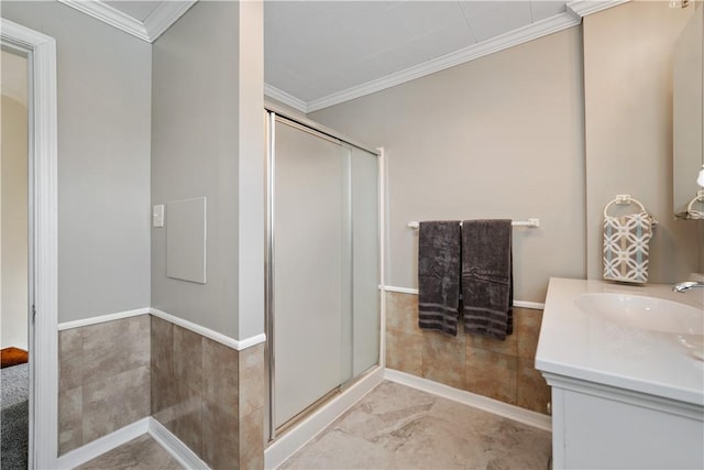 bathroom featuring vanity, ornamental molding, and walk in shower