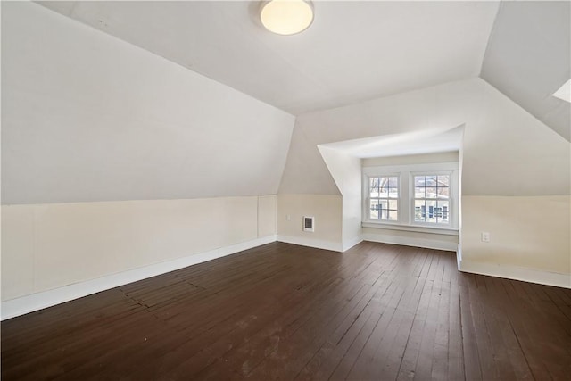 bonus room with vaulted ceiling and dark hardwood / wood-style floors