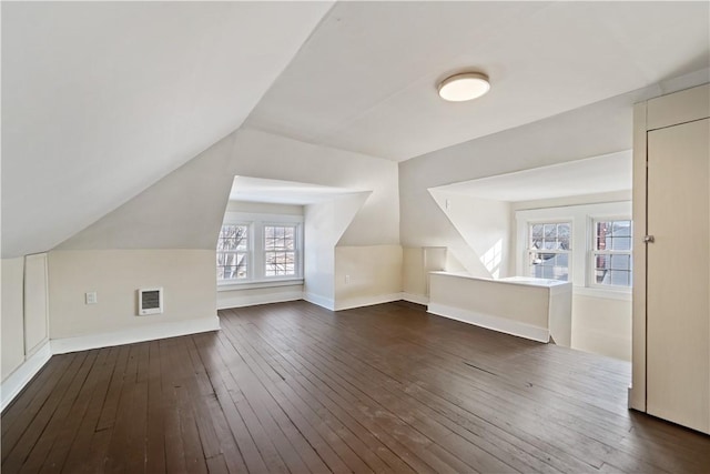 bonus room with lofted ceiling and dark hardwood / wood-style flooring