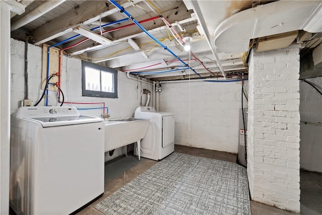 laundry room featuring separate washer and dryer and electric water heater