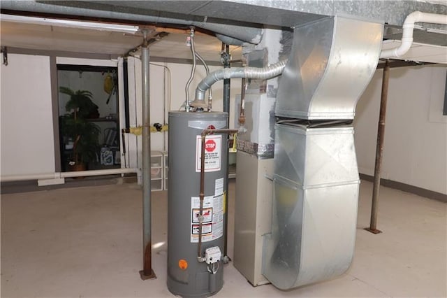 utility room featuring heating unit and gas water heater