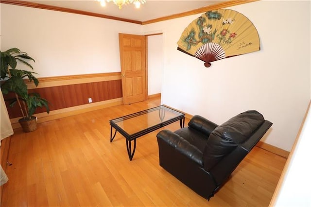 living room featuring ornamental molding and wood-type flooring