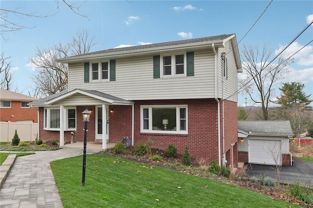 view of front of home featuring a garage and a front lawn