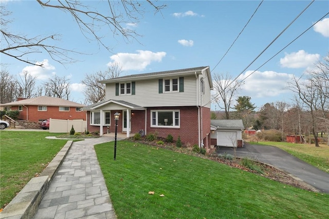 view of front property featuring a garage, a porch, an outbuilding, and a front lawn