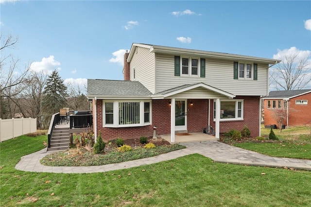 front facade featuring a wooden deck and a front lawn