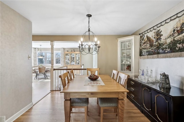 dining area featuring a chandelier and light hardwood / wood-style flooring