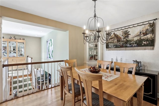 dining area with an inviting chandelier and hardwood / wood-style floors