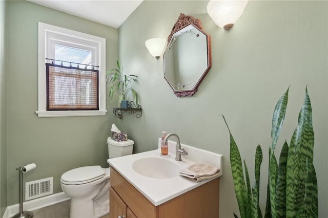 bathroom featuring toilet and vanity