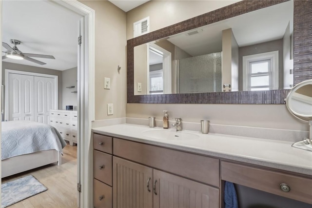 bathroom featuring ceiling fan, vanity, and hardwood / wood-style flooring