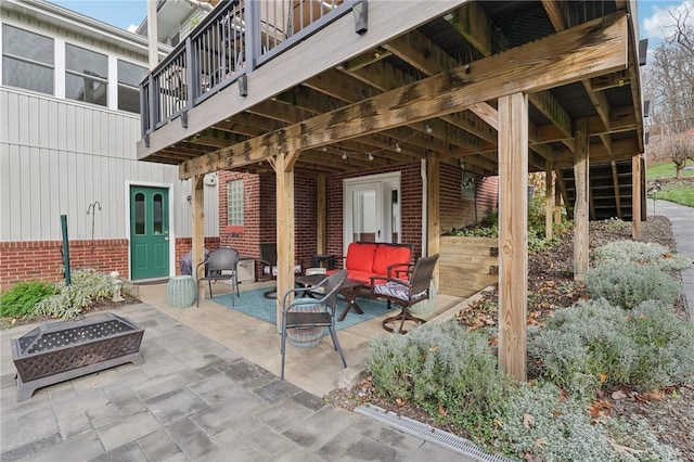 view of patio featuring an outdoor living space with a fire pit