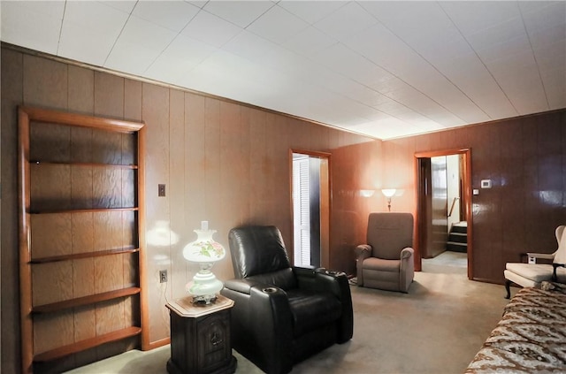 interior space featuring wood walls and light carpet