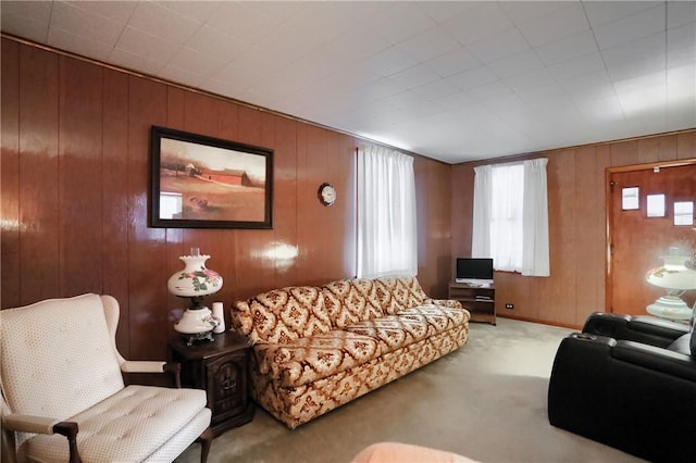 living room with carpet floors and wood walls