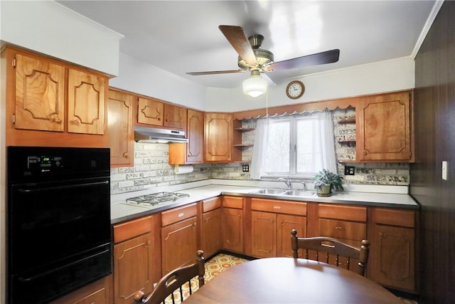 kitchen featuring stainless steel gas cooktop, black oven, backsplash, and sink