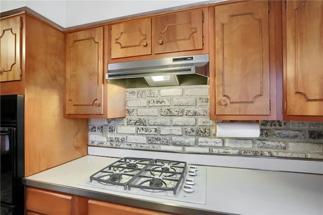 kitchen featuring refrigerator and tasteful backsplash