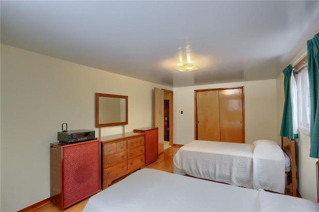 bedroom featuring a closet and light wood-type flooring