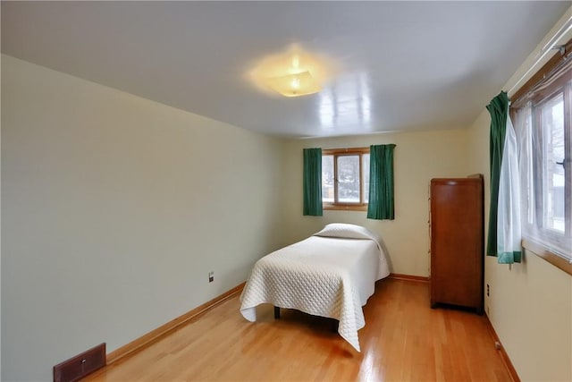 bedroom with light wood-type flooring