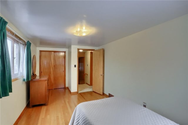 bedroom featuring a closet and light hardwood / wood-style flooring