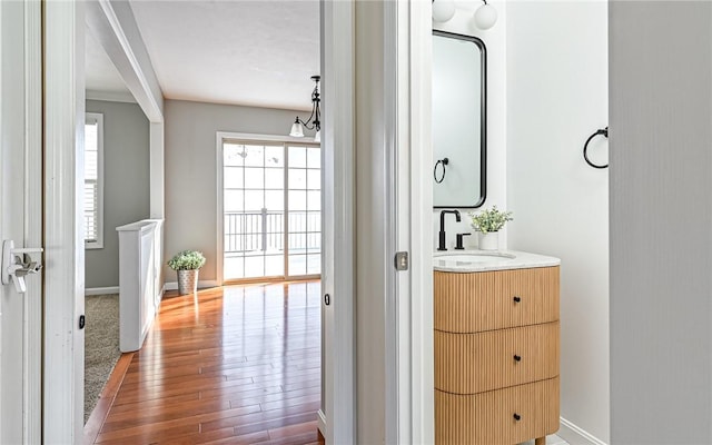 bathroom with vanity, hardwood / wood-style flooring, and a notable chandelier