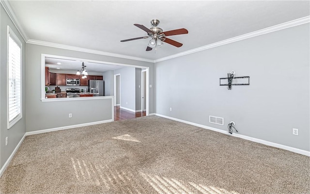 unfurnished living room featuring ceiling fan with notable chandelier, ornamental molding, and dark colored carpet