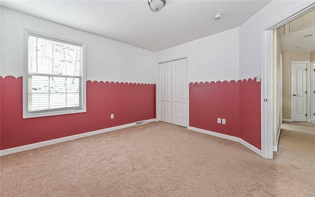 carpeted empty room with a healthy amount of sunlight