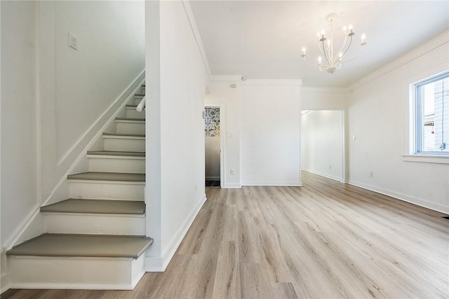 stairs featuring crown molding, a chandelier, and hardwood / wood-style flooring