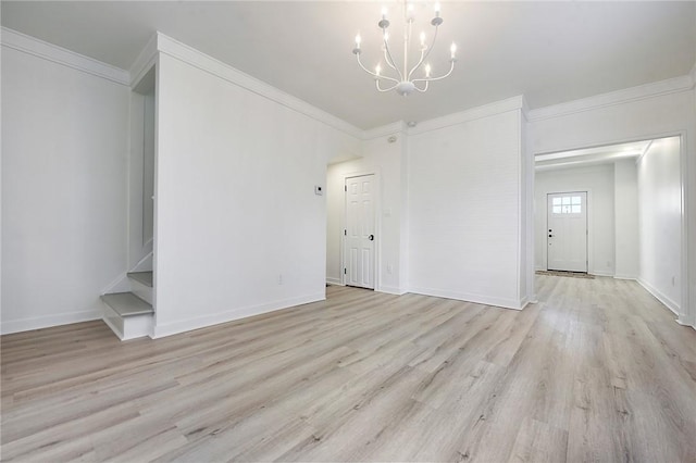 interior space featuring ornamental molding, light hardwood / wood-style flooring, and a chandelier