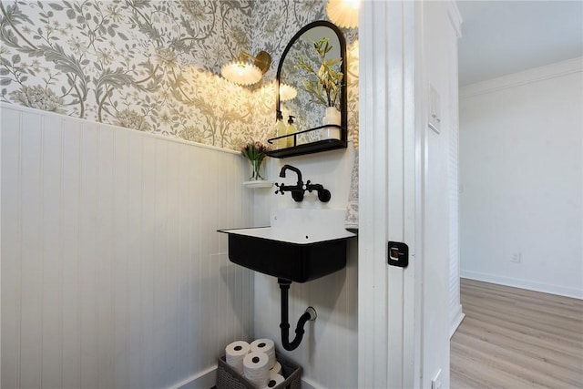 bathroom with hardwood / wood-style floors and crown molding