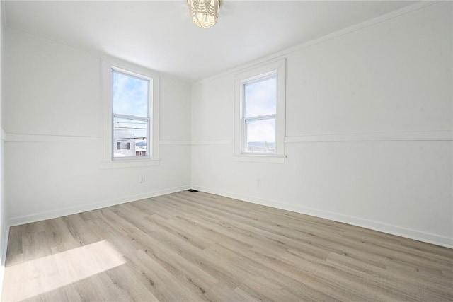 spare room featuring light hardwood / wood-style flooring