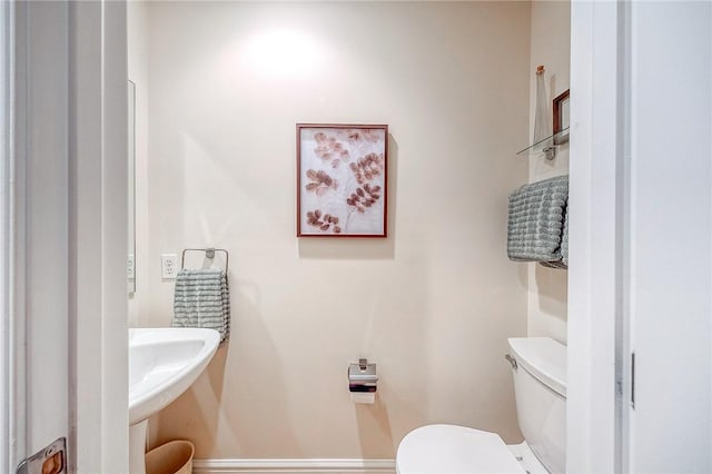 bathroom featuring toilet and sink