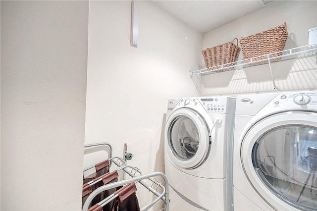 clothes washing area featuring washer and dryer