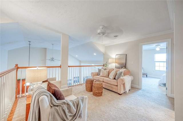 living room featuring a textured ceiling, vaulted ceiling, crown molding, ceiling fan, and light carpet