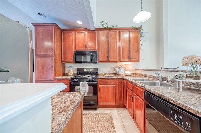 kitchen with black appliances, hanging light fixtures, light tile patterned floors, a textured ceiling, and sink