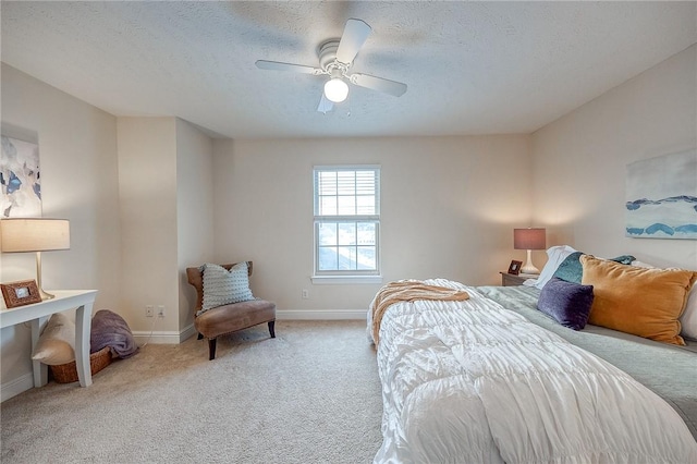 carpeted bedroom with a textured ceiling and ceiling fan