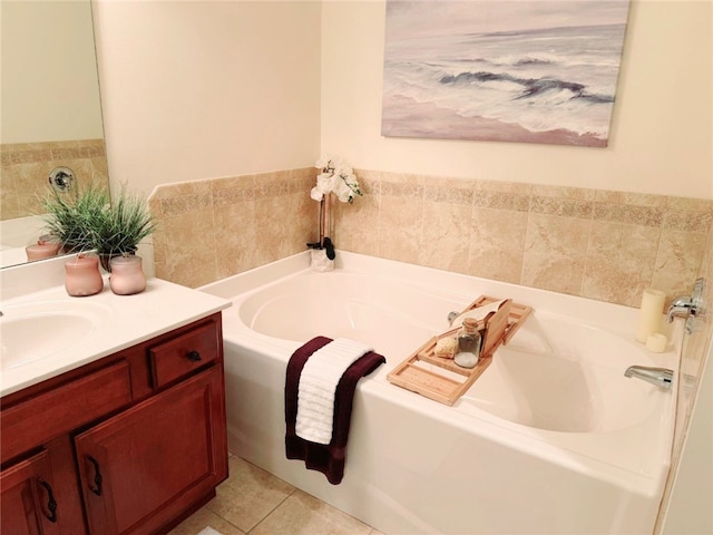 bathroom featuring tile patterned floors, a tub to relax in, and vanity