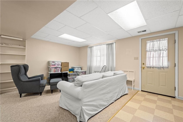 living room featuring a drop ceiling