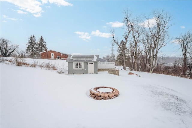 yard covered in snow with an outdoor structure