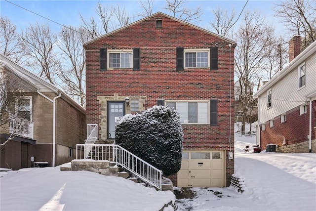 view of front of home featuring central AC unit and a garage