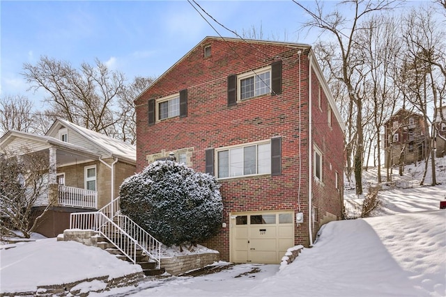 view of snow covered exterior featuring a garage