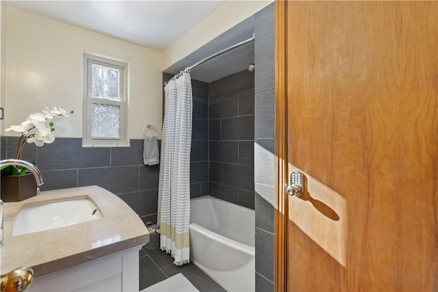 bathroom with vanity, shower / bath combo, tile patterned flooring, and tile walls