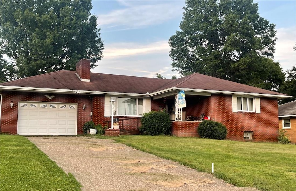 view of front of house featuring a garage and a front lawn