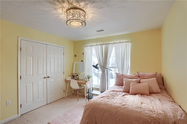 carpeted bedroom with a closet