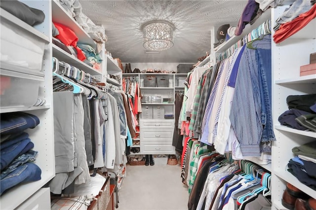 spacious closet with a notable chandelier