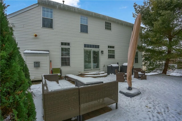 snow covered house with an outdoor living space