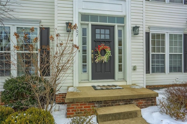 view of snow covered property entrance