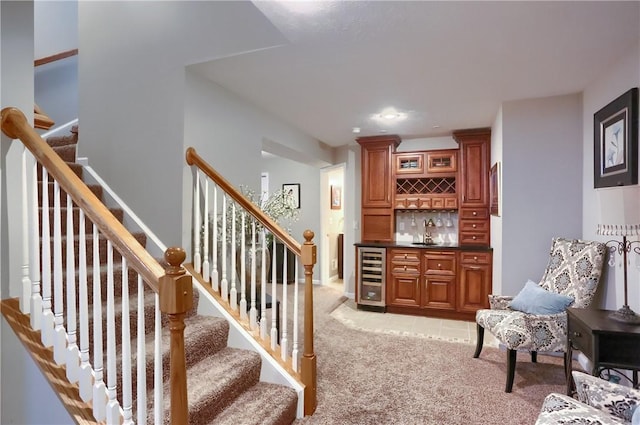 interior space featuring bar, carpet floors, and beverage cooler