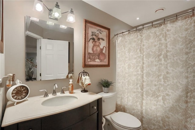 bathroom with vanity, toilet, and a shower with shower curtain